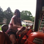Yamilet on tractor at anita's barn